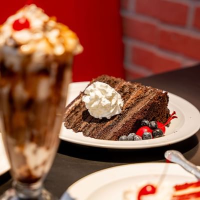 Slice of chocolate cake with berries and a sundae served in a restaurant at Showboat Hotel & Resort