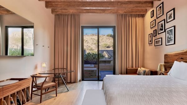 Bed, chairs and table in Sundeck Suite at Live Aqua Resorts