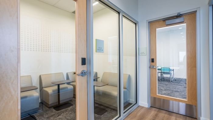 Various bright co-study rooms with large windows, plenty of seating and tables.