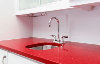 La Rouge Suite featuring a kitchenette with a sink and vibrant red details.