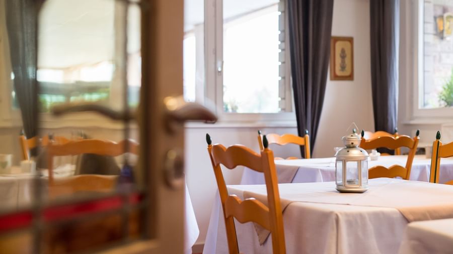 Dining tables set up in the restaurant at Le Kastelberg