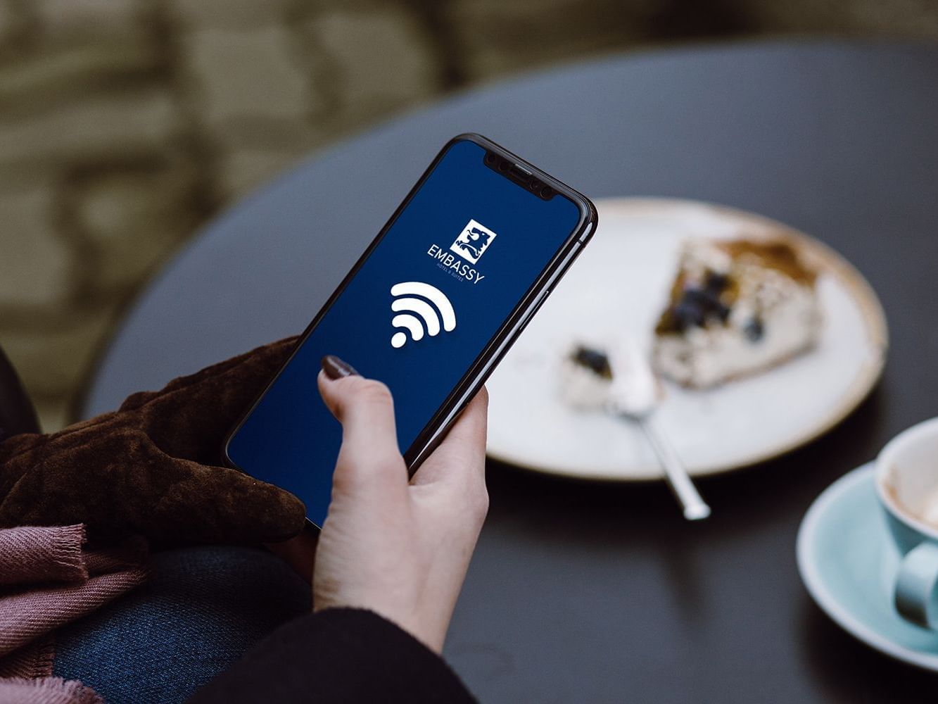 woman holding phone with wifi signal