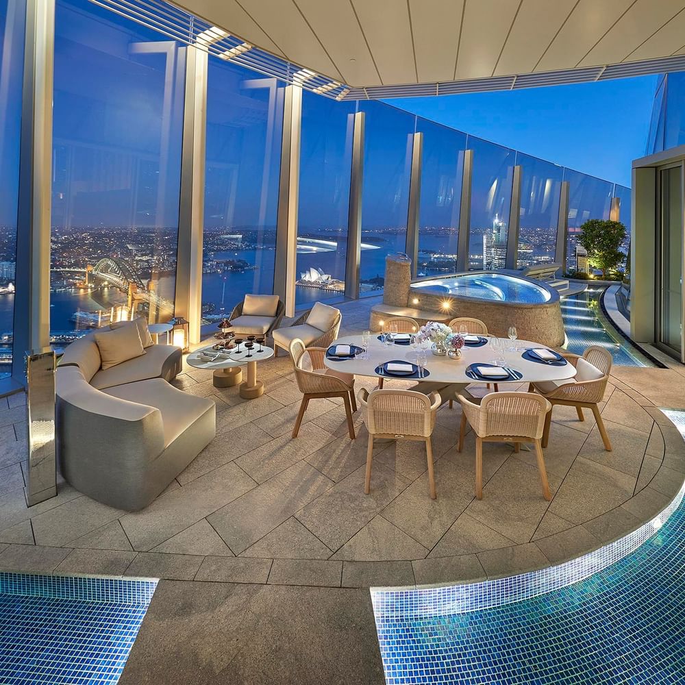 Private dining & lounge area by a jacuzzi overlooking the city at night in Crown Hotels