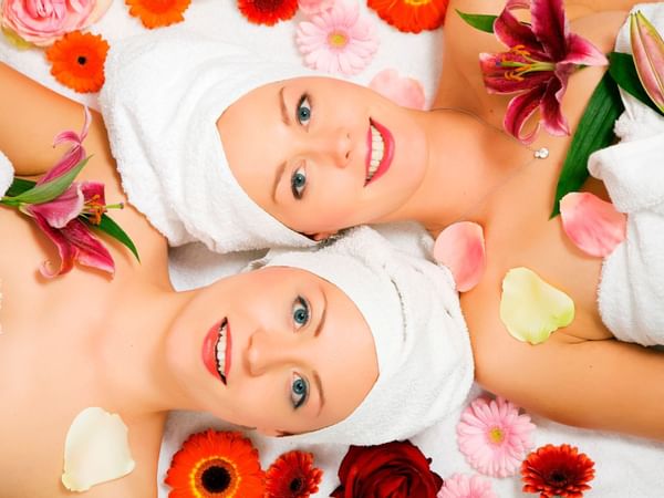 two women in towels covered in flowers