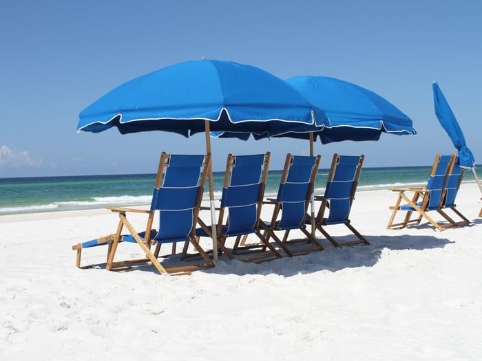 Sunbeds & umbrellas lined by the Watersound beach at Watersound Inn