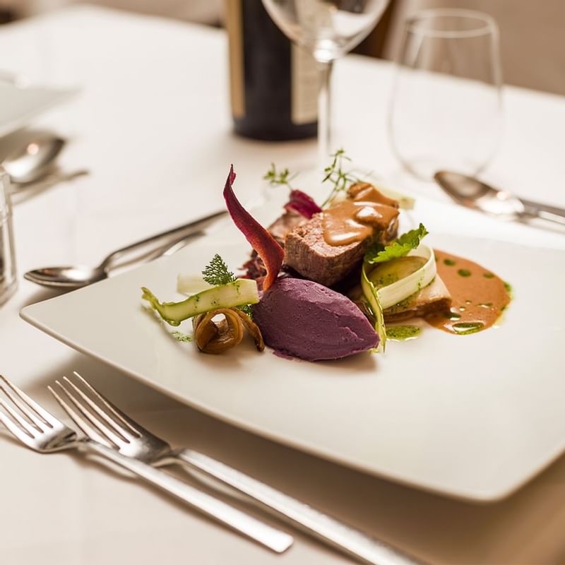 Fine dishes served on a table at Falkensteiner Hotels