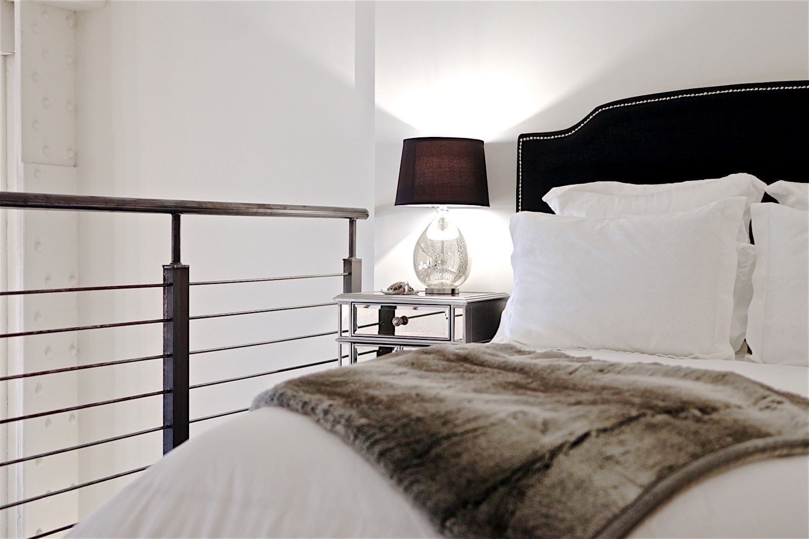 Close-up of Bed with pillows in Loft Style at The Mayo Hotel