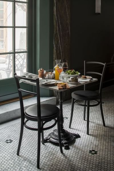 Dishes on a table in Wine Bar & Bistro at The Sparrow Hotel