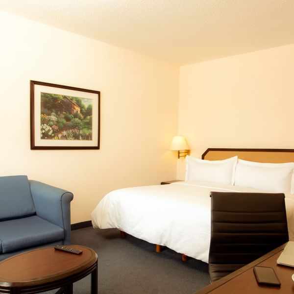 King bed in Superior Room with living area at Fiesta Inn