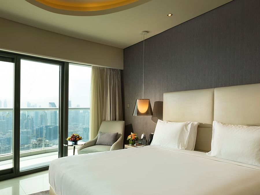 Serviced Apartment with large bed, floor-to-ceiling windows, and city view at DAMAC Maison Aykon City, a luxury hotel in Dubai