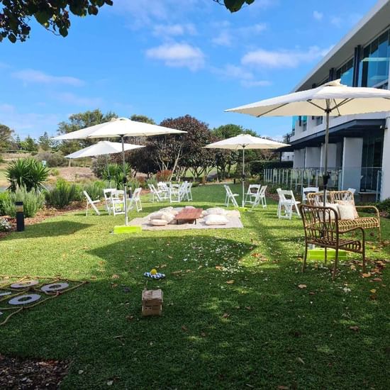 event on lakeside casual sitting with umbrellas and lawn games