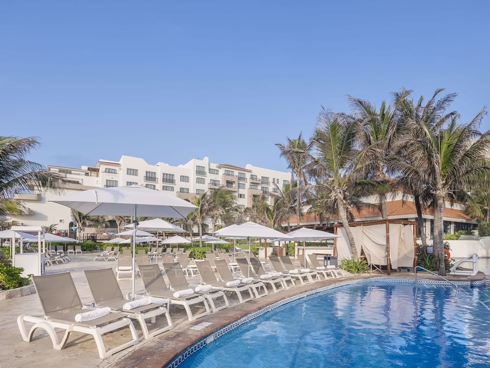 Swimming pool with sun loungers at FA Hotels & Resorts