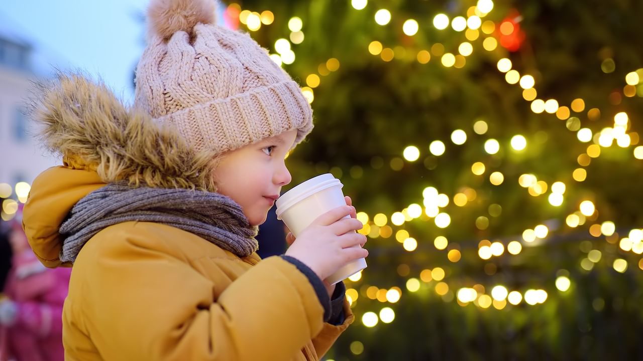 Child sips from a cup, embodying the festive spirit at the Season Festival event at  Coast Lonsdale Quay Hotel