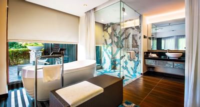 The bathroom with a bathtub and shower in a room