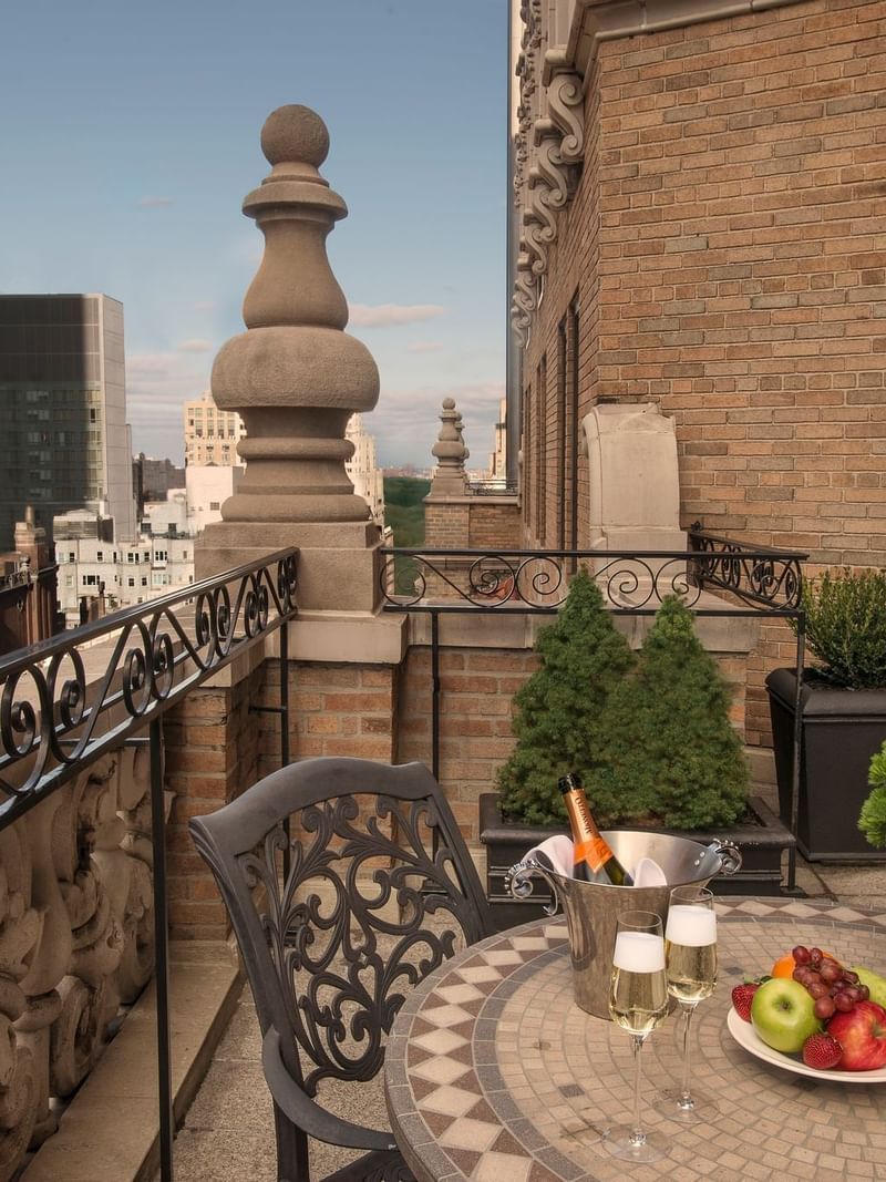 Terrace view with city skyline, wine, and fruit platter at Warwick New York in New York