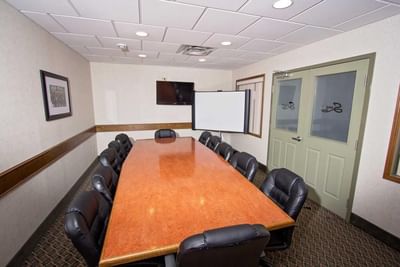 Boardroom set-up with TV in the Meeting Room at Service Plus Inns & Suites Drayton Valley