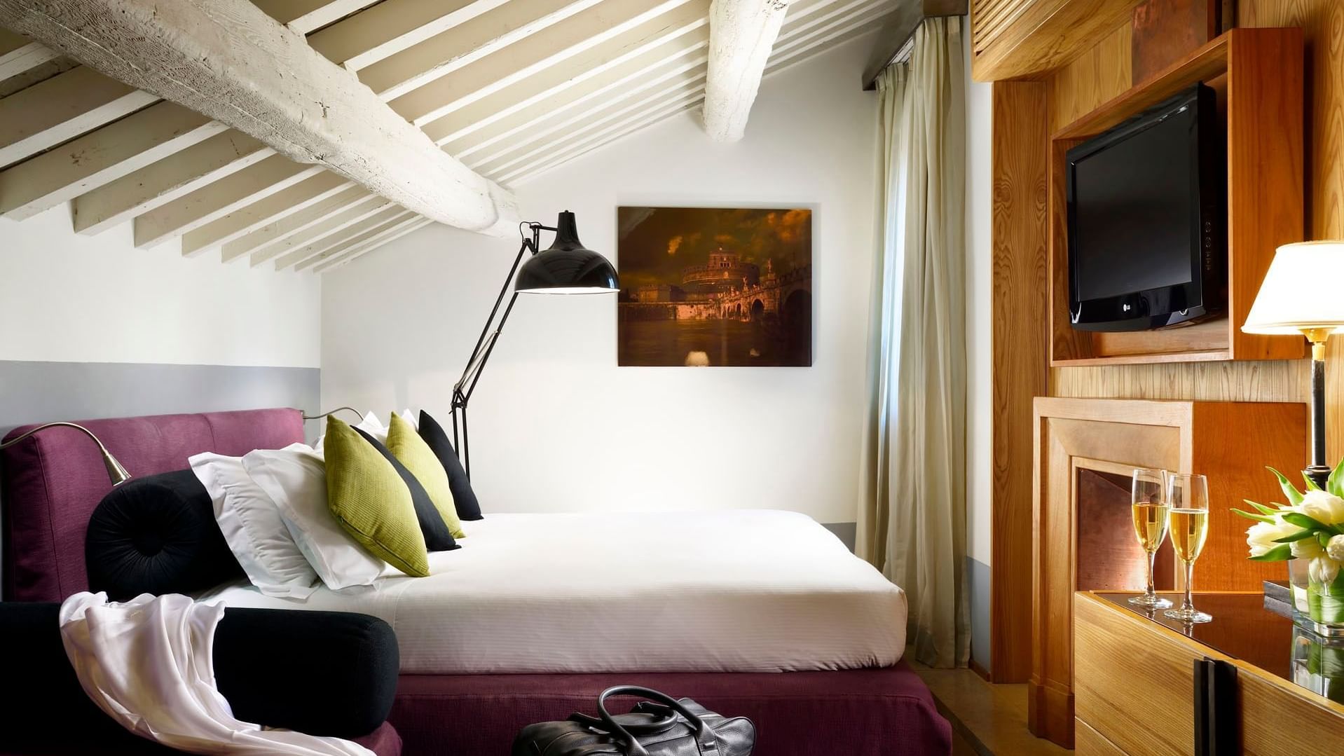 Comfy bed and TV in Rooftop Suite's Bedroom at Mario de’ Fiori 37