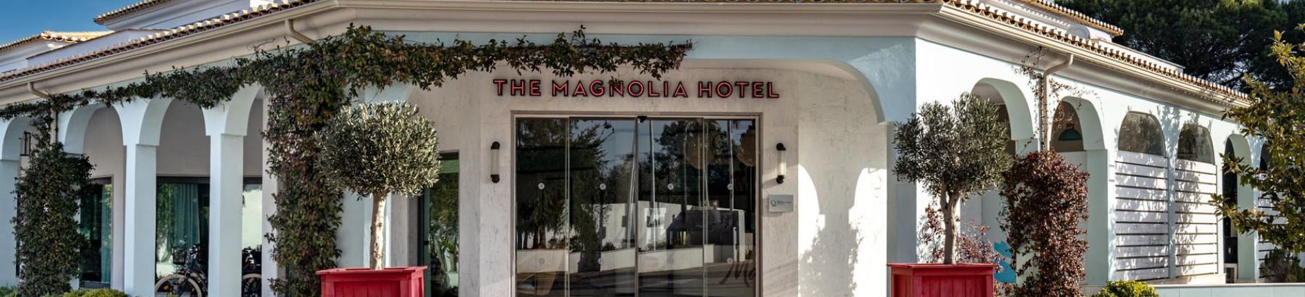 Front exterior of the hotel entrance to The Magnolia Hotel