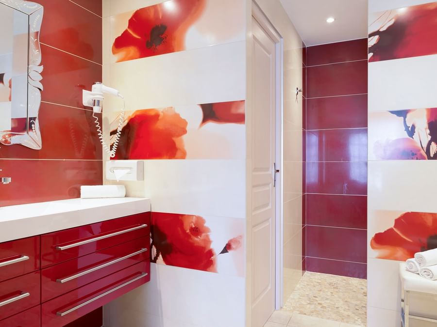 Bathroom vanity in rooms at Hotel Restaurant Les Coquelicots