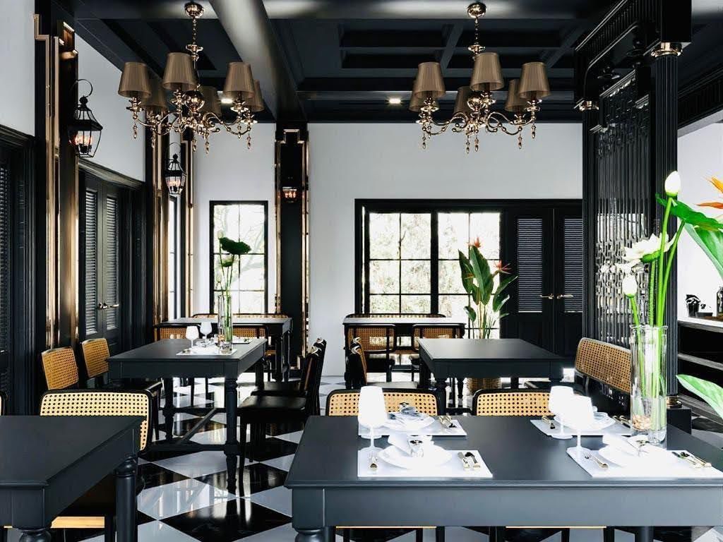 Dining area with chandeliers and large windows in Lotus & Lemongrass at U Luang Prabang