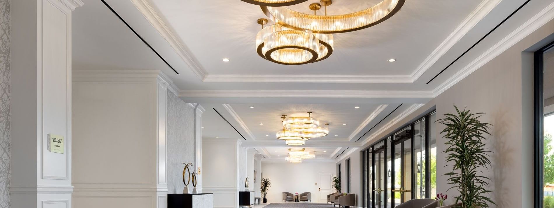 Triple ring crystal chandelier under a recessed ceiling in Turtle Creek Ballroom at Warwick Melrose Dallas