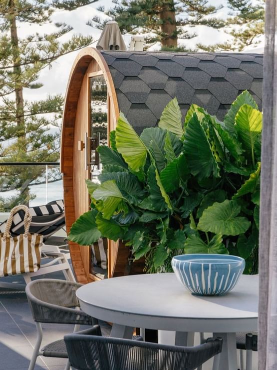 Wellness Suite Twin at Elysium Manly beside tropical leaves under a shingled roof, one of the best places to stay in Manly
