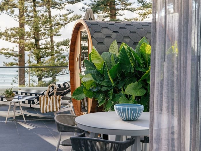 Wellness Suite Twin at Elysium Manly beside tropical leaves under a shingled roof, one of the best places to stay in Manly
