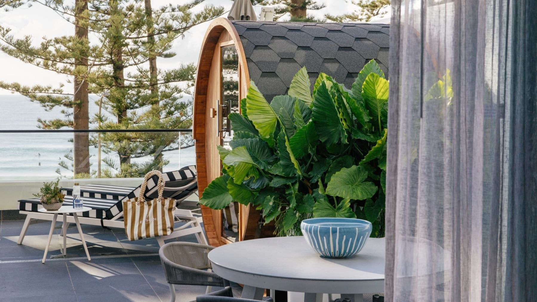 Wellness Suite Twin at Elysium Manly beside tropical leaves under a shingled roof, one of the best places to stay in Manly