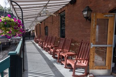 Outdoor seating area with armchairs in a balcony at River Street Inn