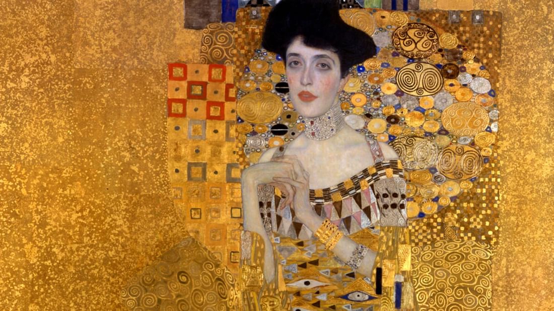 Gustav Klimt posing in a golden patterned background at Almanac Palais Vienna featuring Vienna hotel offers