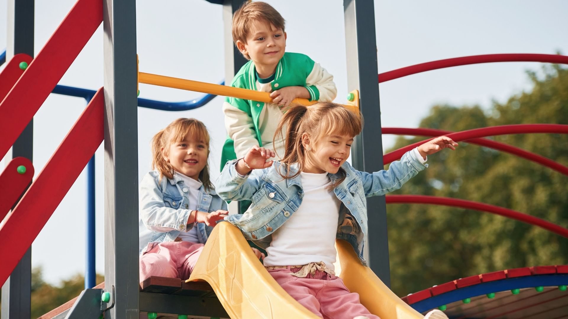 Happy children playing on a colorful slide in Parque Centenario near Real Inn Mexicali