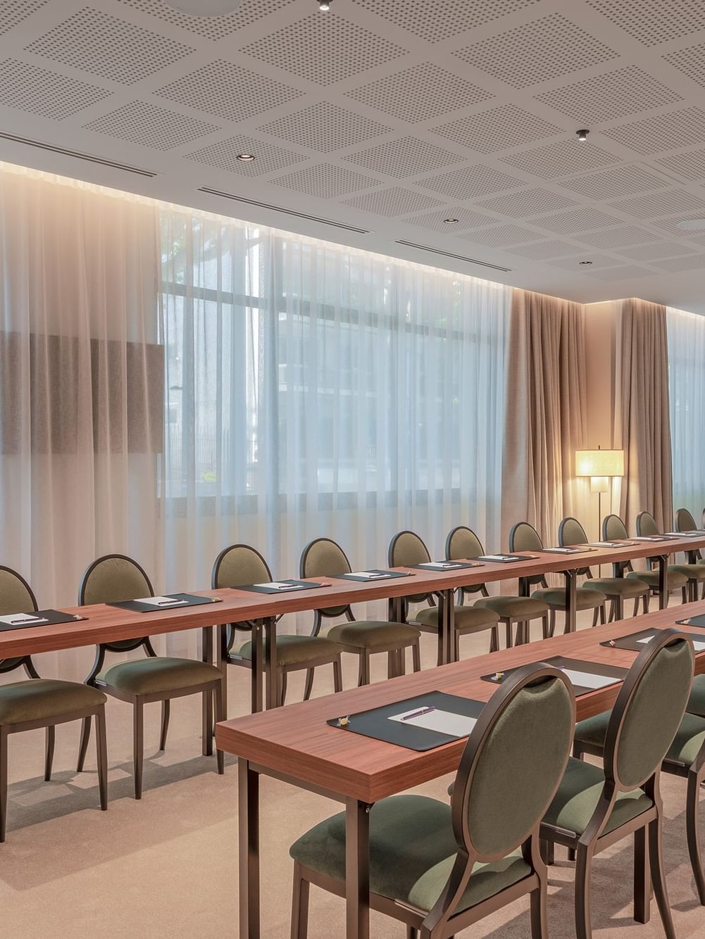 Elegantly arranged event room with long tables and chairs at Warwick Reine Astrid - Lyon in Lyon.