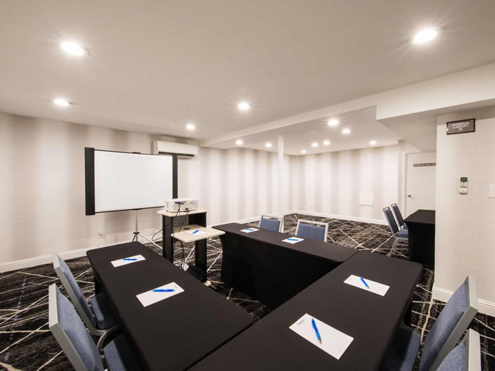 U-shape table set up in Seacrest Conference Room with black & blue interior at SeaCrest Oceanfront Hotel Pismo Beach