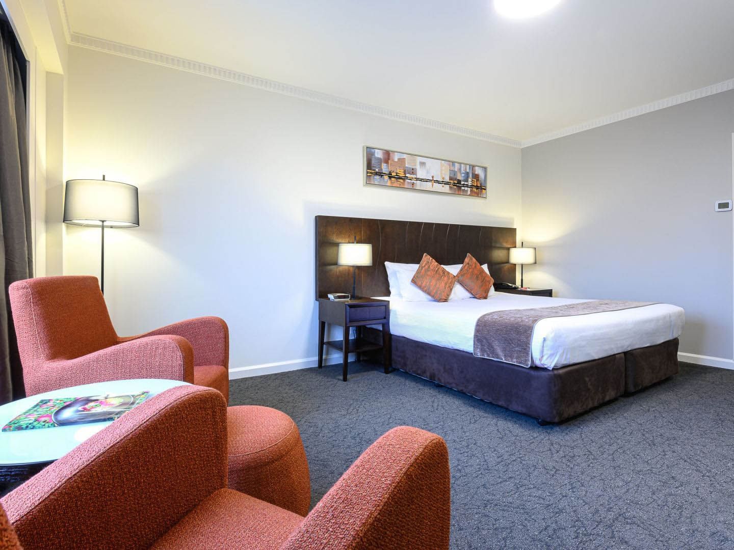 Bed & chairs in Executive King at Grand Chancellor Adelaide