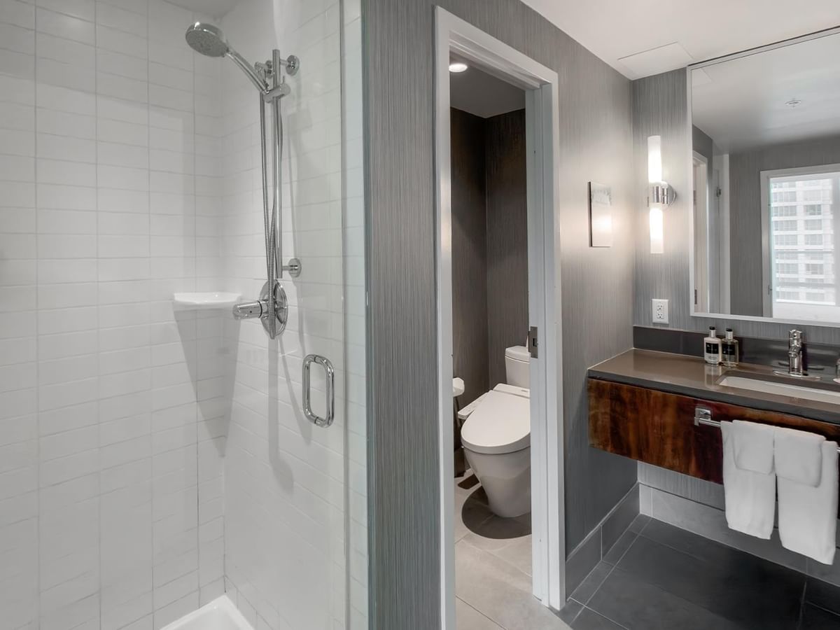 Modern bathroom with shower stall, toilet, and sink.