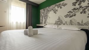 Closeup of folded towels on a bed at Originals Hotels