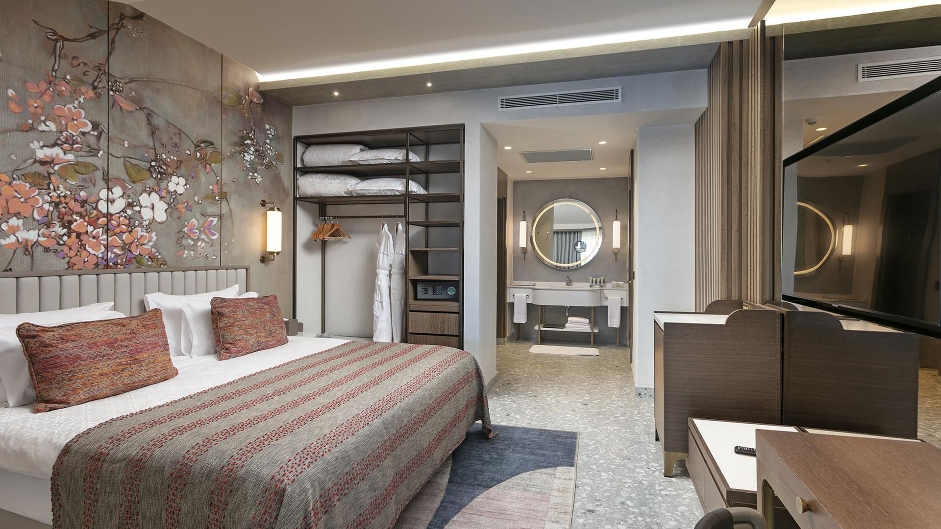 Bedroom with TV, wall art behind the king bed & closet in Family Roof Suite with Jacuzzi at Cullinan Belek