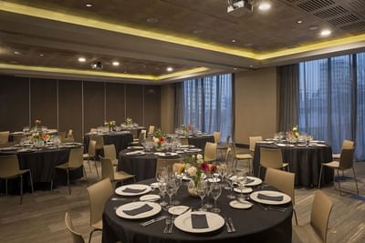 Banquet round tables set for a formal dinner event under modern lighting highlighting meeting Chile at Veranda Hotel