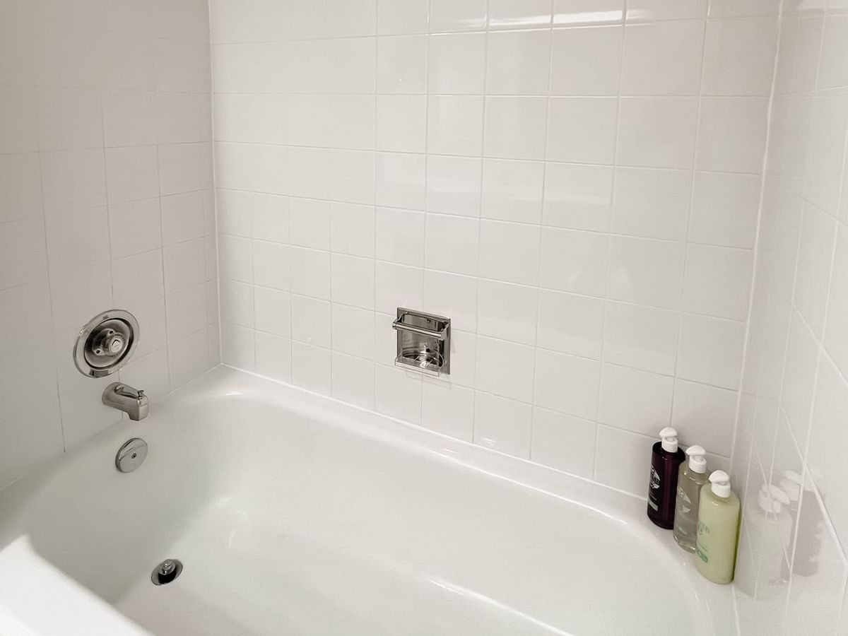 Bath with bottles of shampoos, body washes