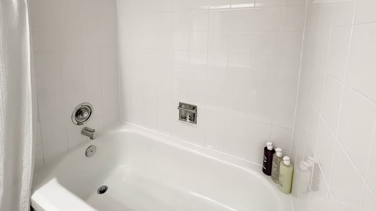 Bath with bottles of shampoos, body washes