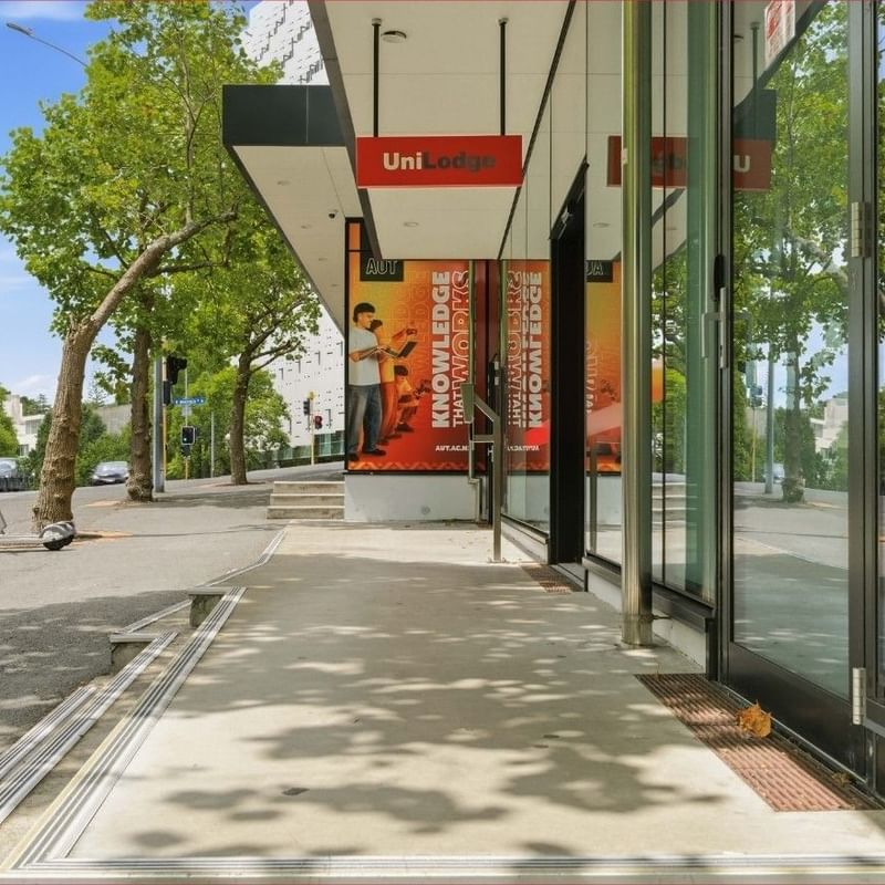 Mayoral Drive Student Accommodation building entrance with glass walls and promotional banners on display.
