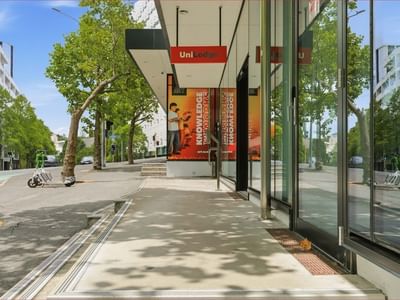 Mayoral Drive Student Accommodation building entrance with glass walls and promotional banners on display.