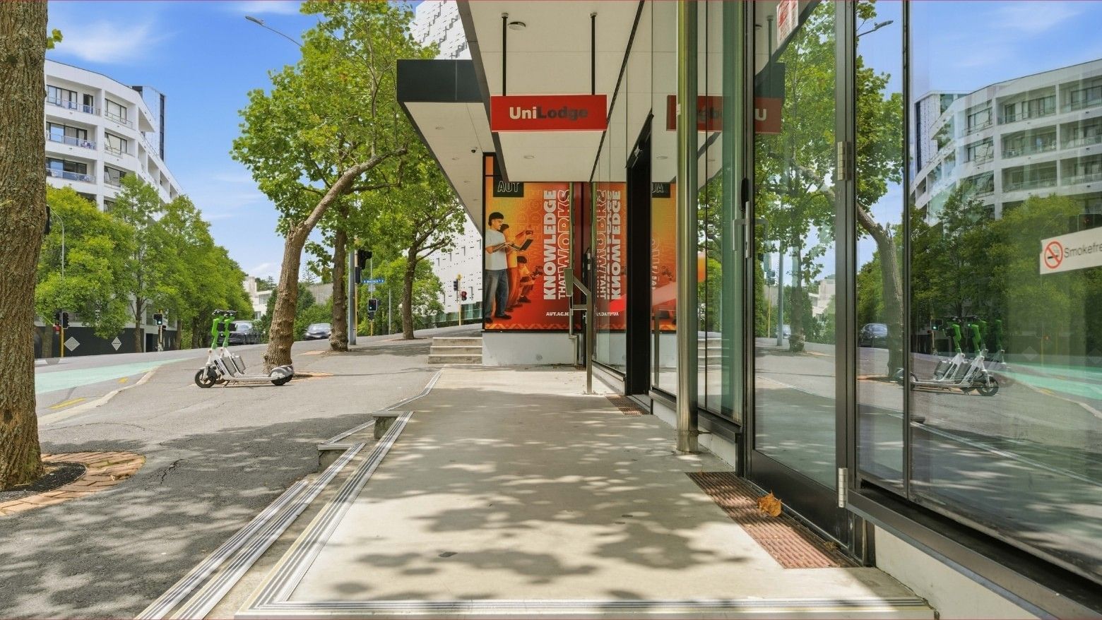 Mayoral Drive Student Accommodation building entrance with glass doors and promotional banners.