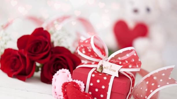 Romantic display with red roses, gift box, and hearts for Little Sweetheart Package.