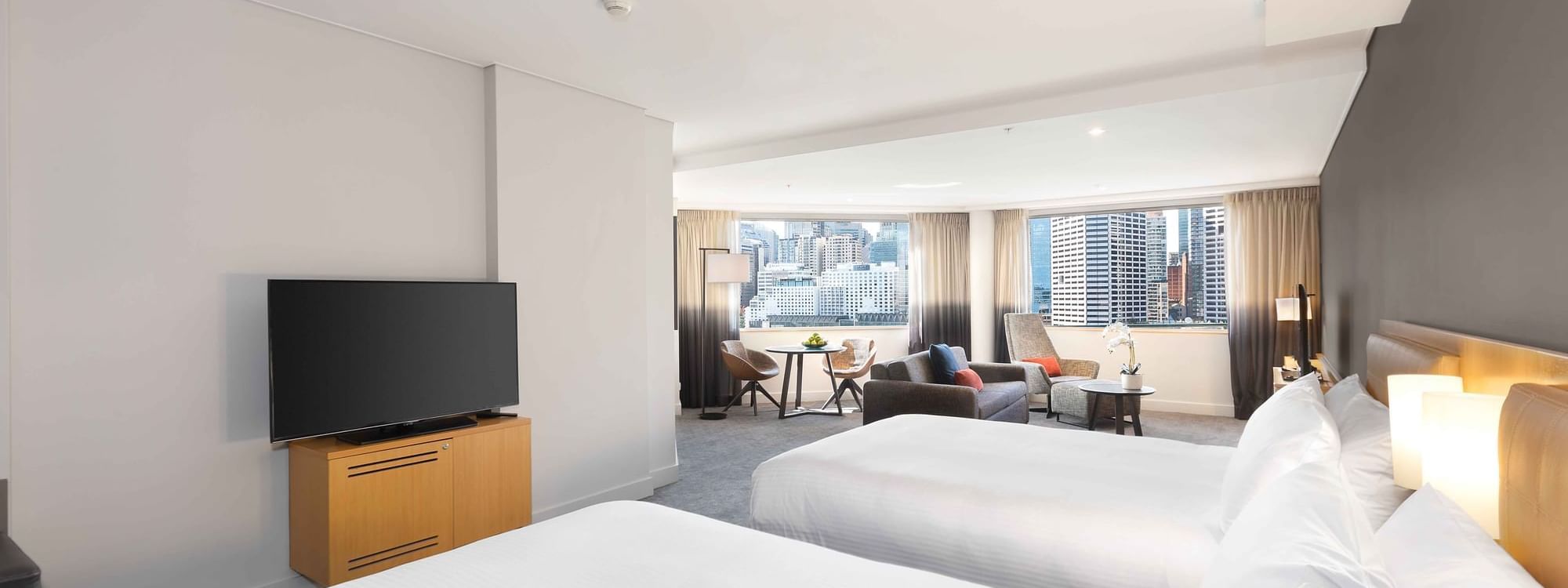 Spacious bed room and living area with Two double beds in Executive Suite at Novotel Sydney on Darling Harbour