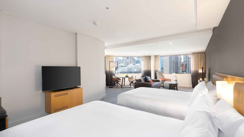 Spacious bed room and living area with Two double beds in Executive Suite at Novotel Sydney on Darling Harbour