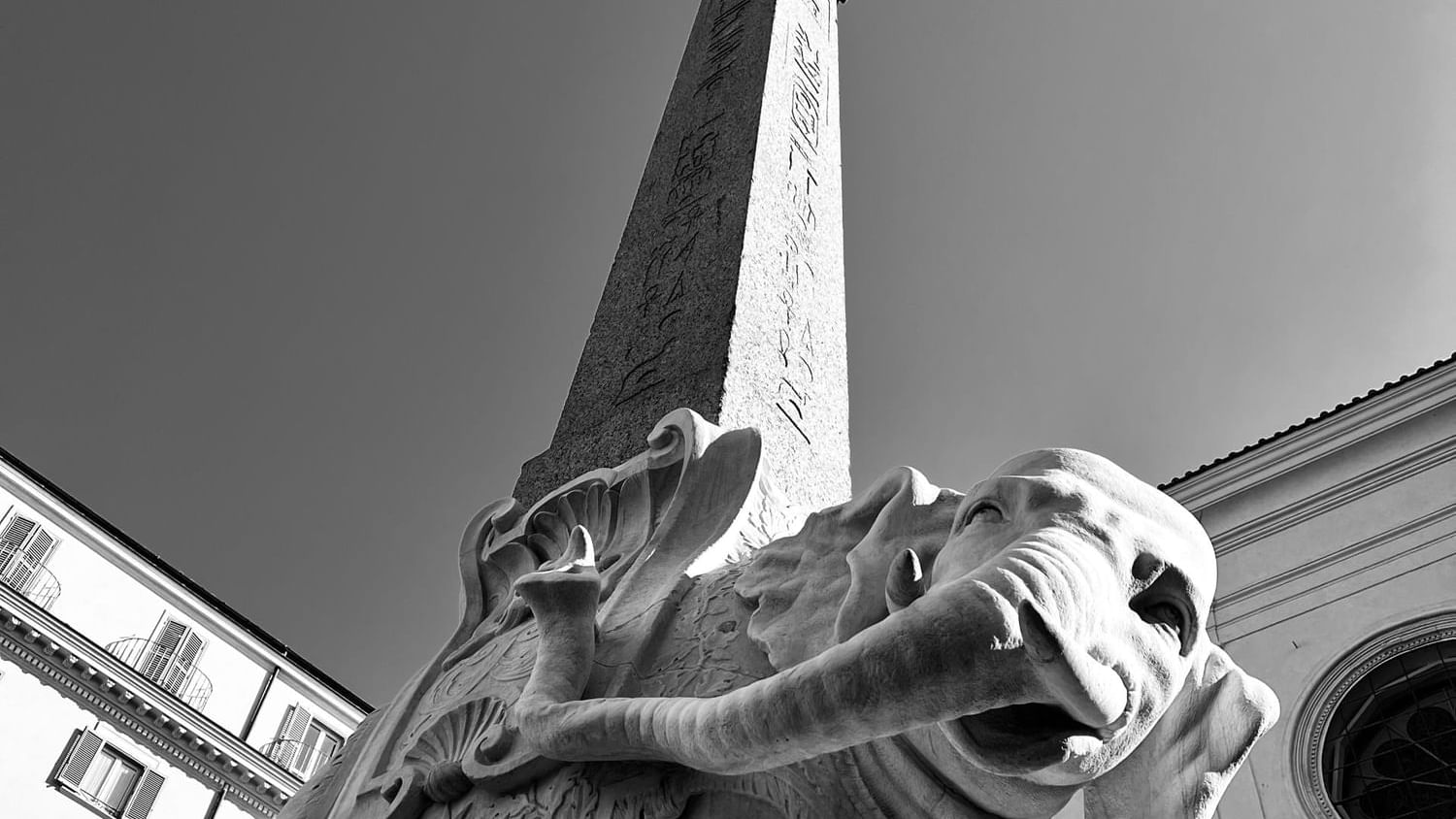 Low-angle view of the tower with elephant statue in Basilica of Saint Mary of Minerva near Rome Luxury Suites