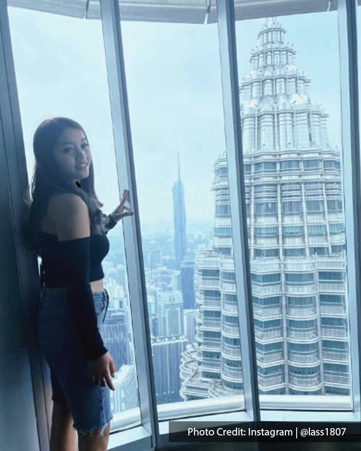 Girl posing on the Sky Deck of Petronas Twin Towers, famous local attraction in Imperial Lexis Kuala Lumpur