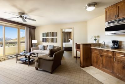 Suite interior with balcony, living area, and kitchen at Elevation Resort Spa