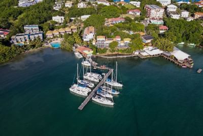 Aerial view of the hotel & parked boats at True Blue Bay Hotel